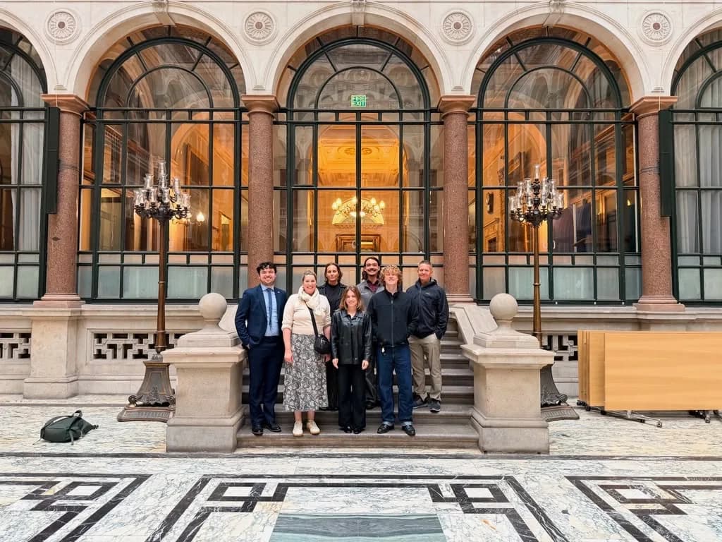 The Arterial team with agency staff on the steps of a civic building